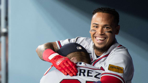 Sep 2, 2023; Los Angeles, California, USA; Atlanta Braves shortstop Orlando Arcia (11) celebrates with major league coach Eddie P rez (95) in the dugout after hitting a triple RBI home run against the Los Angeles Dodgers during the 10th inning at Dodger Stadium.